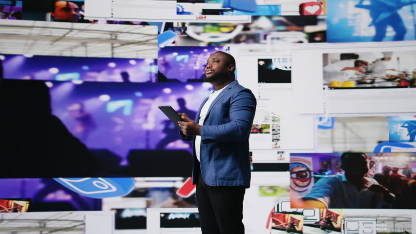 African american digital creator interacting with high tech visuals and screens, illustrating cloud based systems, e commerce trends and big data in web networking tech environment. Camera A. - Powered by Shutterstock - Get 15% off with code: PIKWIZARD15
