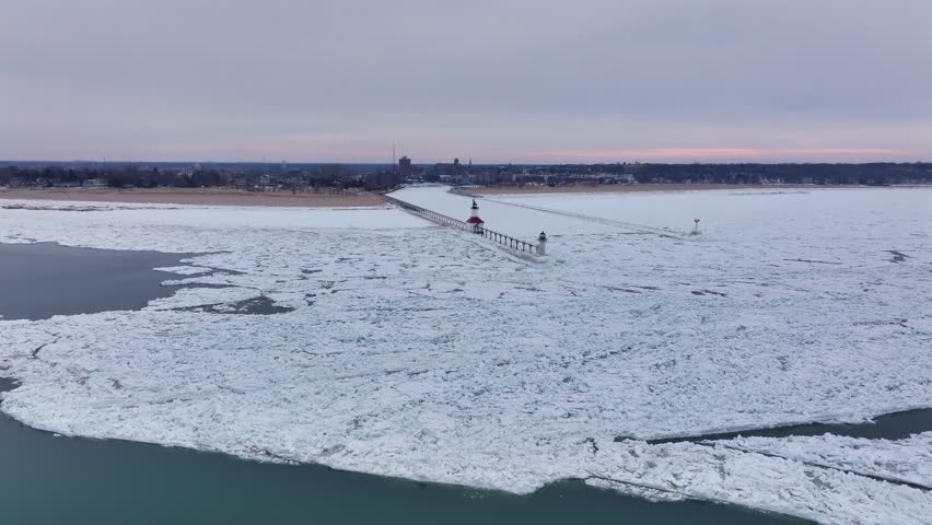 Lighthouse frozen Lake Michigan drone view