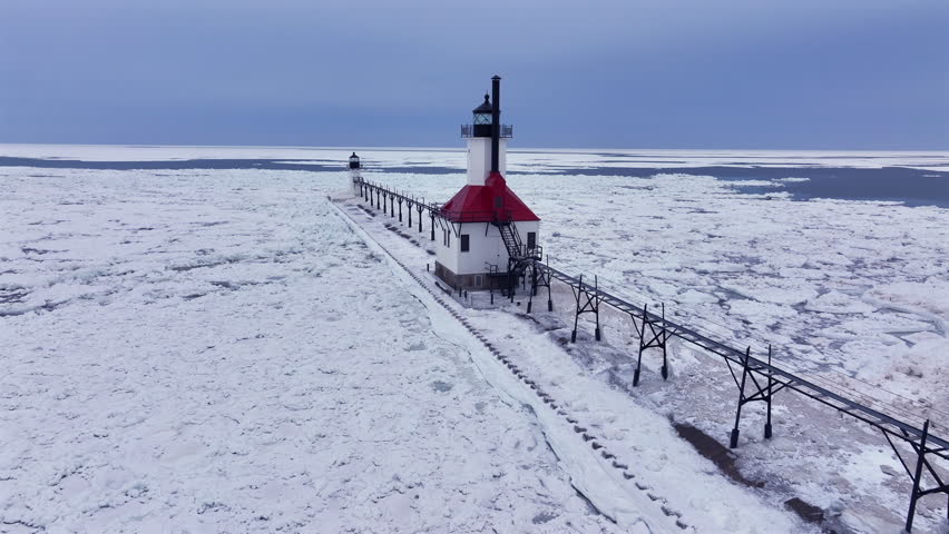 Lighthouse frozen Lake Michigan drone view