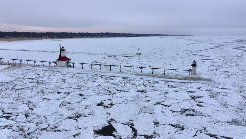 Lighthouse frozen Lake Michigan drone view