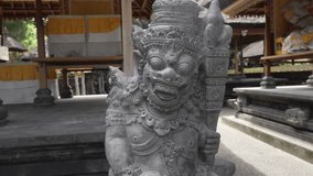 Camera tracks closer to a Balinese deity sculpture at Goa Gajah Temple, Ubud, Indonesia. - Powered by Shutterstock - Get 15% off with code: PIKWIZARD15