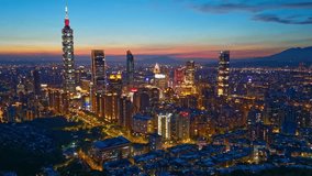 Aerial hyperlapse of Downtown Taipei at dusk, the vibrant capital city of Taiwan, with 101 Tower standing out amid skyscrapers in XinYi Commercial District and city lights dazzling under twilight sky - Powered by Shutterstock - Get 15% off with code: PIKWIZARD15