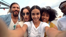 Group of cheerful multi ethnic friends taking a selfie on a rooftop party, enjoying their time together - Powered by Shutterstock - Get 15% off with code: PIKWIZARD15