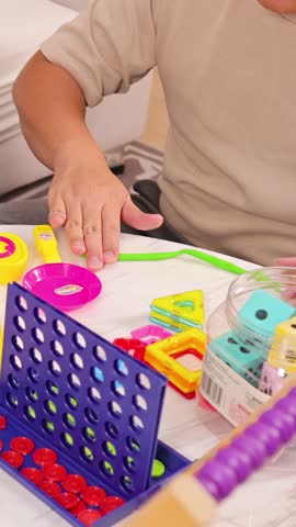 A family enjoys quality time playing with modeling clay and toys in a cozy living room setting