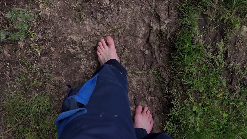 Man walks on the ground with bare feet.