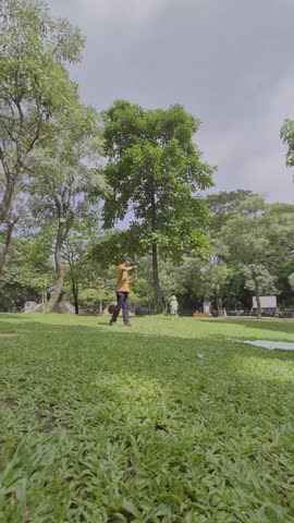 Father and daughter enjoy some free time in a vibrant city park with walking paths, greenery and family activities. sstkTravel