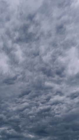 Vertical time-lapse captures dark, dense storm clouds churning across the sky. The ominous grey formations move quickly, creating a dramatic and moody atmosphere perfect for social media stories.