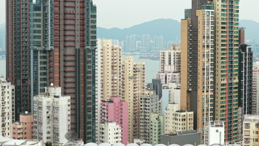 Hong Kong Urban Sprawl Expanding Towards The Sea. Urban Landscape Of Hong Kong Revealing Dense Residential High-Rises Stretching Toward Sea, Representing City