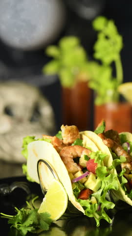 Festive serving of Tacos with crispy fried shrimp for Halloween. Vertical slow motion video movement in a circle