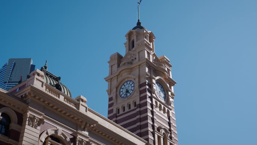 Exterior of Flinders Street Station in Melbourne Victoria with people walking passed and the famous clocktower