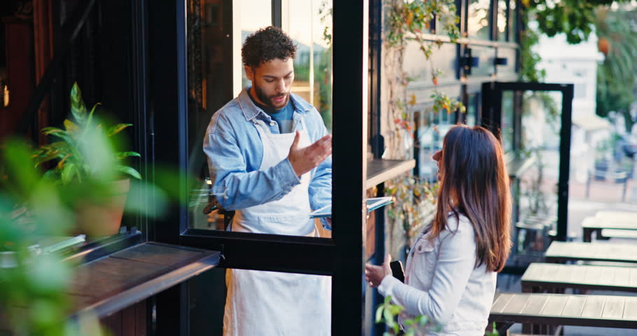 Welcome, restaurant and waiter with woman at door for friendly service, greeting and hospitality. Diner, cafe and man with customer at entrance for small business, opening and coffee shop startup