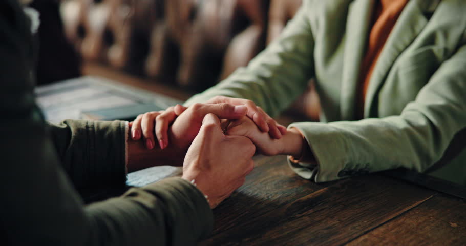 Love, couple and kiss hand at restaurant for bonding together, admiration and connection. Anniversary date, romance and people with affection at cafe for commitment, respect and devotion to marriage