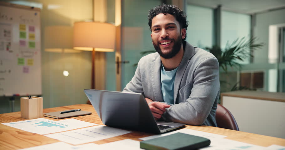 Face, business and man with laptop in office for accounting, finance graphs and revenue report at night. Male person, pc and documents for payroll audit, review budget and deadline for tax compliance