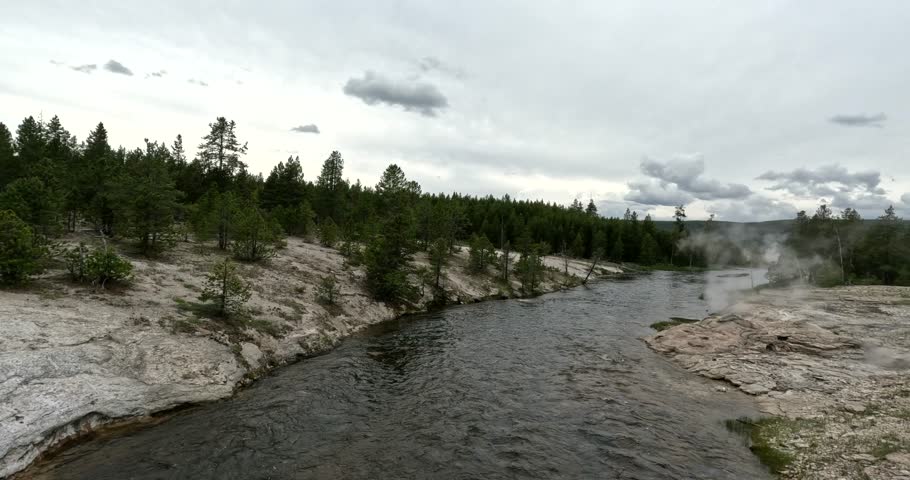 Firehole River Flowing Through The Ancient, Volcanic, Geothermal, Landscapes Of Yellowstone National Park In Wyoming, USA; 4K Walking Tourist POV.