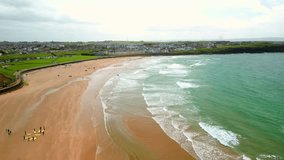 Advancing aerial video of West Strand Beach in Portrush in County Antrim in Northern Ireland on a bright and sunny summer day. Produced in 4K, 60 frames per second and with Rec709 color. - Powered by Shutterstock - Get 15% off with code: PIKWIZARD15