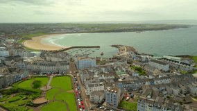 Wide advancing overhead video of West Strand Beach in Portrush in County Antrim in Northern Ireland on a bright and sunny summer day. Produced in 60 frames per second, 4K and with Rec709 color. - Powered by Shutterstock - Get 15% off with code: PIKWIZARD15