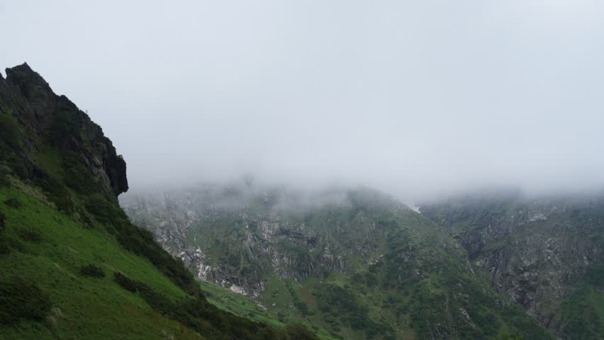 Timelapse of Fog Drifting Over Rocky Mountain Pass – Lush Green Himalayan Landscape