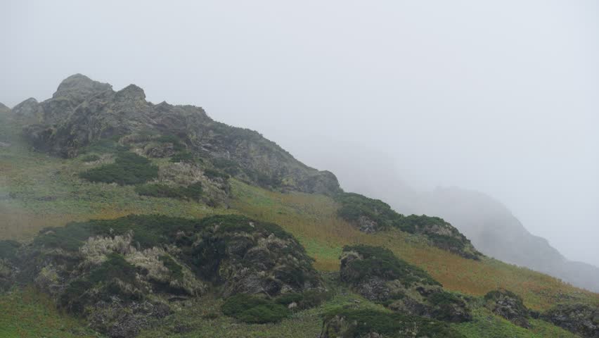 Timelapse of Mist Covering Rocky Mountain Slope  Cloudy Himalayan Landscape in Monsoon