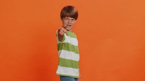 I choose you. Happy young preteen child boy kid pointing finger forward to camera, choosing lucky game winner, indicating to awesome you, promotion. Smiling little children on orange background - Powered by Shutterstock - Get 15% off with code: PIKWIZARD15