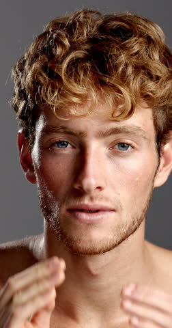 Beauty, face and laughing with man in studio for hygiene, masculine grooming or skincare wellness. Aesthetic, cleaning and self care with funny model on gray background for facial dermatology