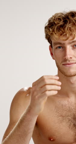 Beauty, face and hygiene with happy man in studio for masculine health, grooming or satisfaction. Aesthetic, muscular and skincare with shirtless model on white background for change or dermatology