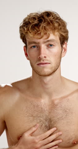 Face, grooming and smile of shirtless man in studio for masculine health, hygiene or wellness. Aesthetic, beauty and skincare with body of happy or muscular model on white background for dermatology