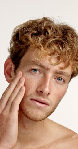 Dermatology, face and man with skincare in studio with healthy skin, hydration treatment or results. Self care, grooming and person with smile for cosmetics routine and wellness on white background