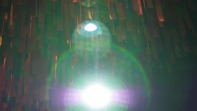 Multicolored ribbons hang on the ceiling, a white spotlight shines into the camera. Fabric multicolored ribbons and fabric at a traditional Indian festival. - Powered by Shutterstock - Get 15% off with code: PIKWIZARD15