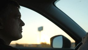 Middle-aged man driving sleek automobile during golden hour, experiencing tranquil moment while navigating a highway with confidential demeanor and focused mindset - Powered by Shutterstock - Get 15% off with code: PIKWIZARD15