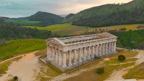 The ancient Doric temple in Segesta, Sicily stands proudly amidst lush landscapes. Its towering columns, set against rolling hills, create a breathtaking historical vista. - Powered by Shutterstock - Get 15% off with code: PIKWIZARD15