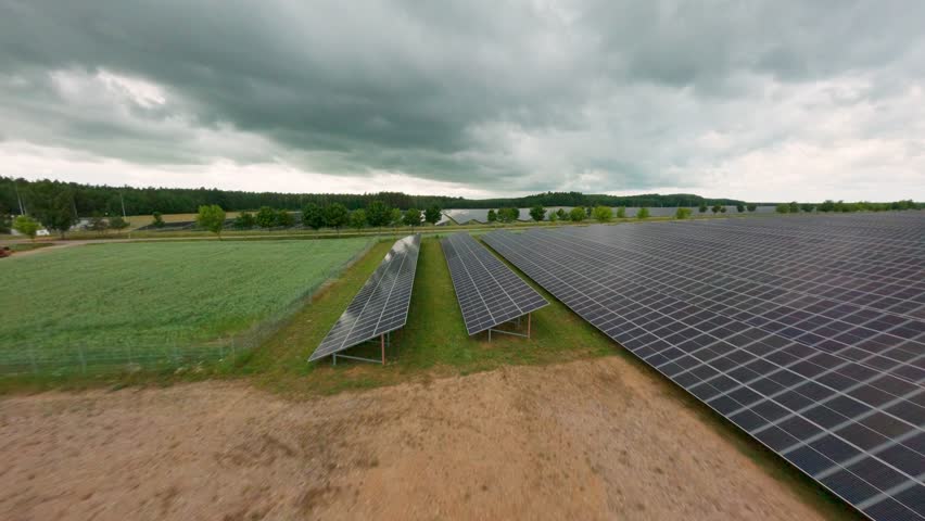 FPV drone glides across solar panel power field