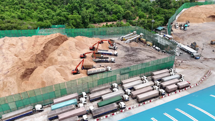 wood chips with backhoe working load unload chip to truck concept green fuel for save earth. renewable energy from wood Chips