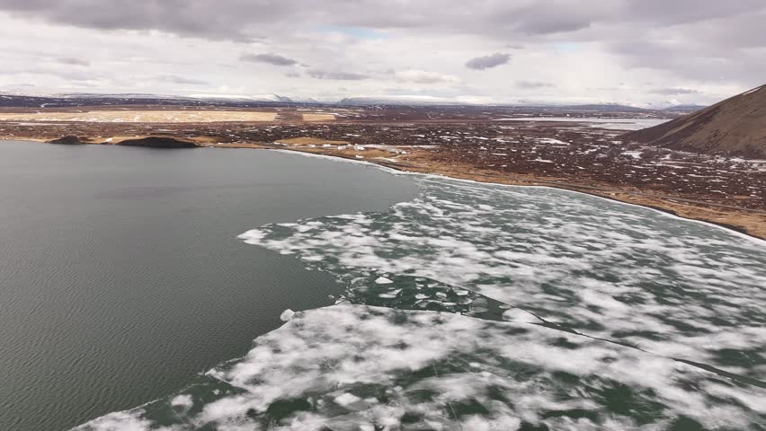Aerial view of breaking lake ice near Skútustaðir and Reykjahlíð during early summer thaw. Mývatn, Iceland