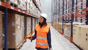Logistics professional wearing safety vest and helmet scanning packages, systematically checking inventory within spacious modern distribution warehouse facility - Powered by Shutterstock - Get 15% off with code: PIKWIZARD15