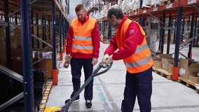 Logistics training, senior employee guiding new worker on pallet jack operation in busy warehouse - Powered by Shutterstock - Get 15% off with code: PIKWIZARD15