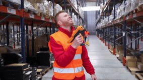Logistics worker scanning barcodes on high shelves using a barcode reader in a large warehouse - Powered by Shutterstock - Get 15% off with code: PIKWIZARD15