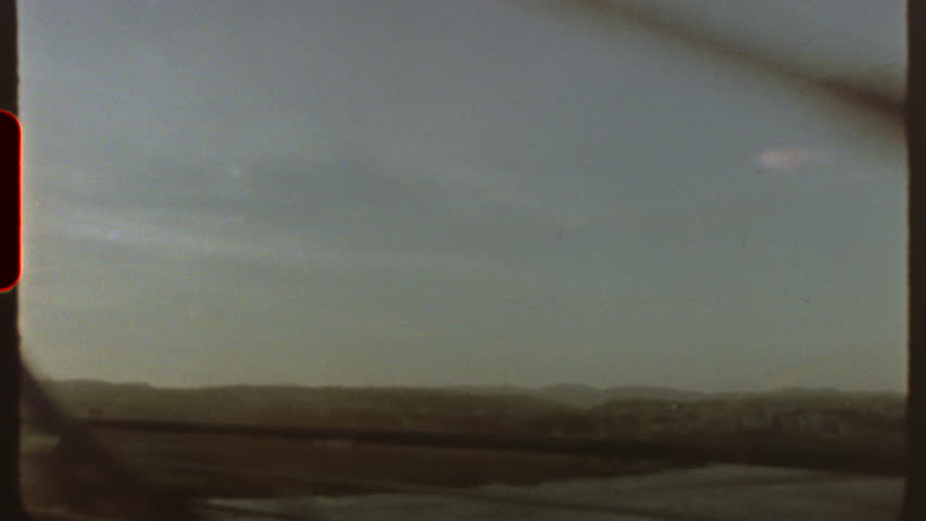 Filmed on super 8 film Vintage vibes emanate from this super 8 film aesthetic, showcasing a journey across a bridge with blurry landscapes in the background