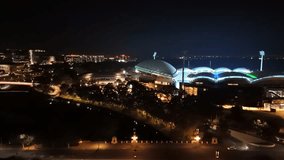 Adelaide City, South Australia, 2 Jul 2025: 4K Aerial Drone Footage Capturing Night Skyline, Adelaide Oval, Festival Plaza, Riverbank Precinct, Footbridge, Illuminated Buildings, Traffic Lights and - Powered by Shutterstock - Get 15% off with code: PIKWIZARD15