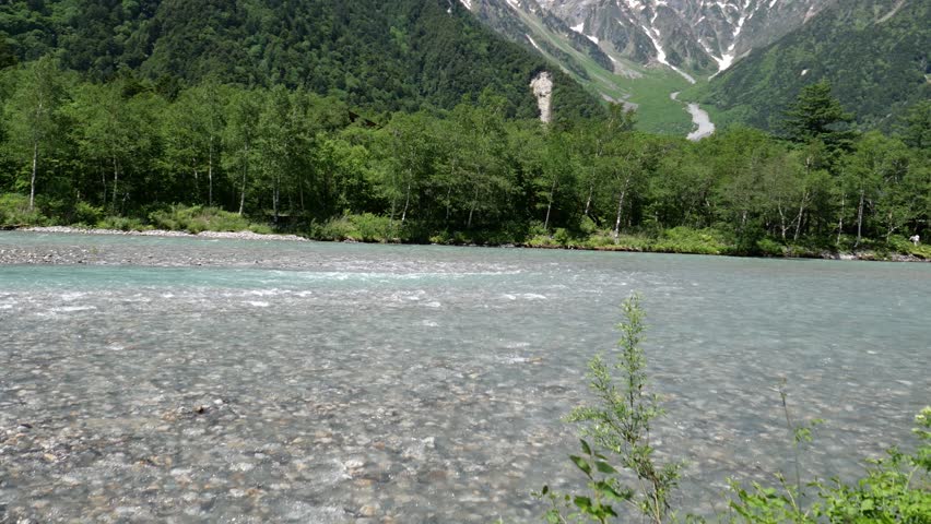 Rivers and bridges on the mountains of Nagano, Japan, with mountaineers walking on the distant trails