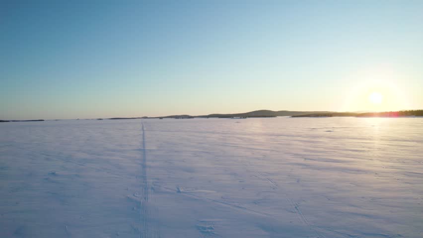 Aerial View of Frozen Lake Inari in Lapland, Finland – Winter Drone Footage