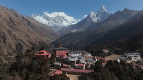Aerial view of Tengboche Monastery nestled in the Himalayas of Nepal, showcasing traditional architecture and a majestic snow-capped peak in the background - Powered by Shutterstock - Get 15% off with code: PIKWIZARD15