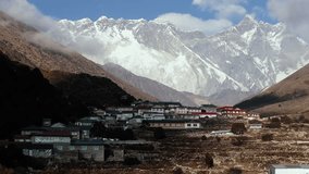 High-angle view of an isolated Nepali village, showcasing heritage architecture and pristine snowy crests - Powered by Shutterstock - Get 15% off with code: PIKWIZARD15