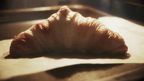raw croissant baking in oven. Buttery dough rising with golden glow on parchment paper. Artisan pastry preparation, homemade breakfast, and cozy morning kitchen atmosphere - Powered by Shutterstock - Get 15% off with code: PIKWIZARD15