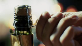 man hands open champagne bottle. hands preparing to open a champagne bottle, highlighting the cork, wire cage foil wrapping. celebration, luxury, special occasions bottle for toasts and festivities - Powered by Shutterstock - Get 15% off with code: PIKWIZARD15