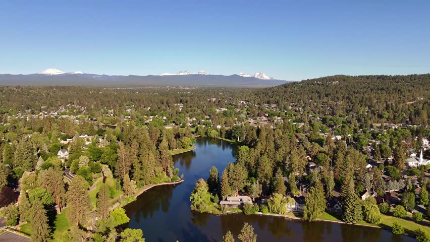 Bend, Oregon, United States. Aerial view of Mirror Pond reflecting the crisp blue sky amidst the town