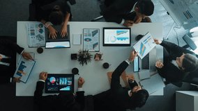Top down aerial view of smart businessman explain financial graph to investor while business team analysis stock market investment chart at meeting table. Diverse group brainstorm idea. Directorate. - Powered by Shutterstock - Get 15% off with code: PIKWIZARD15