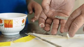 Grandfather and Grandson Building a Kite Together, Applying Glue on Paper Frame at Table - Closeup of Hands, Family Bonding Moment - 4K - Powered by Shutterstock - Get 15% off with code: PIKWIZARD15