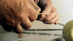 Elderly Hands Crafting a Homemade Kite With Sticks and String on Table - Closeup - 4K - Powered by Shutterstock - Get 15% off with code: PIKWIZARD15