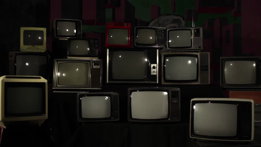 Vintage Televisions Powering On With Brick Wall Texture on Screens, Dark Room, 4K