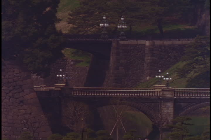 TOKYO - CIRCA MARCH 1998: Tilt up from Nijubashi Bridge to Imperial Palace.